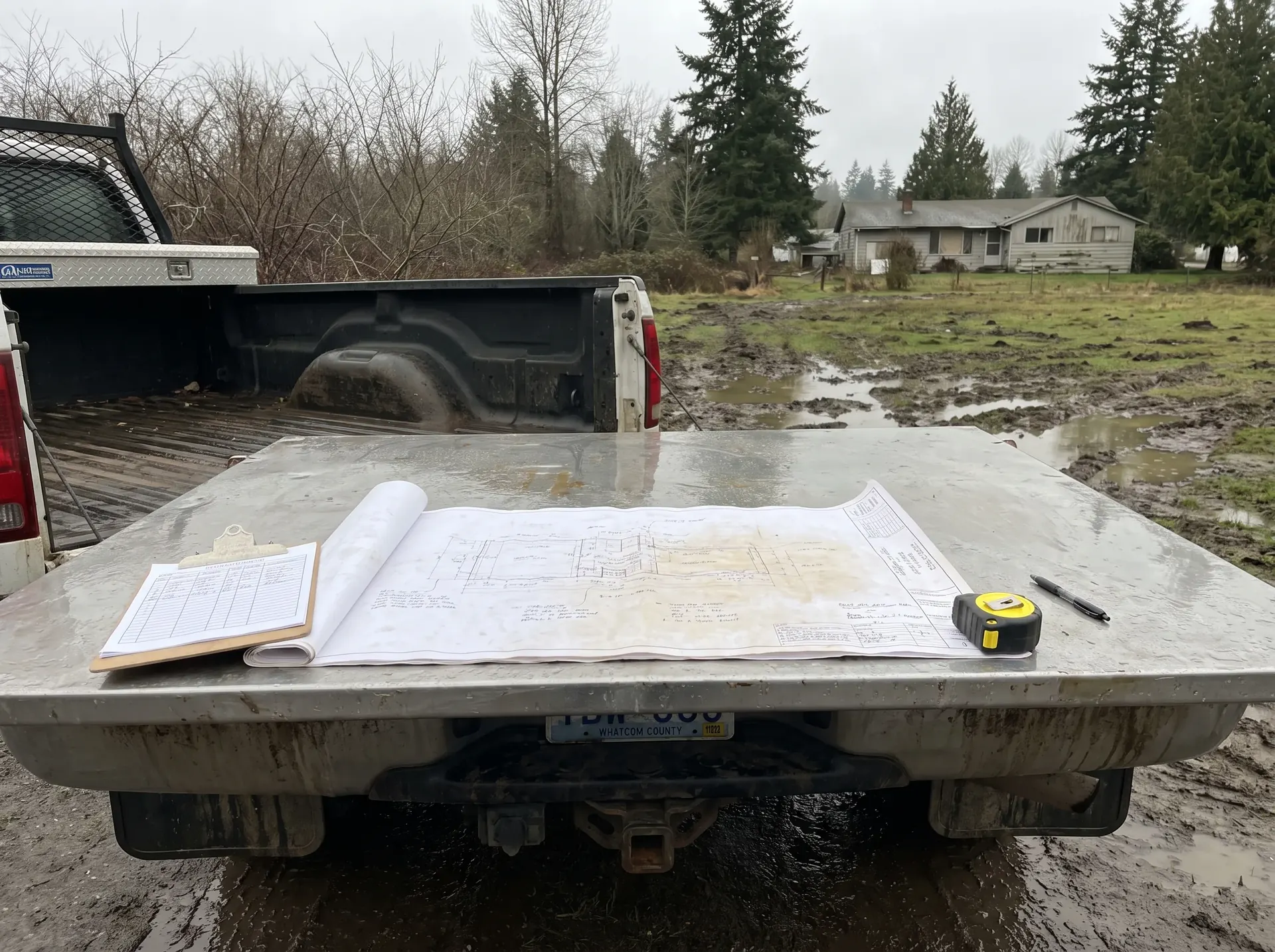 Septic system site plan and soil log on the tailgate of a truck